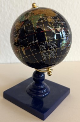 Globus aus Edelsteinen mit Perlmutt-Verzierungen.